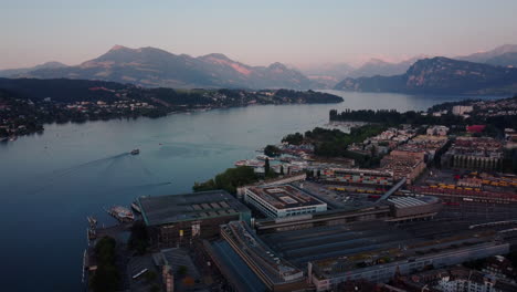 Aerial-overview-of-the-vierwaldstättersee-and-Train-station-and-harbor-of-Lucern-after-sunset