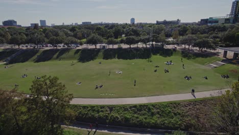 Aerial---People-on-grass-at-Eleanor-Tinsley-Park-in-Houston,-TX-on-a-sunny-day