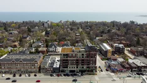 Aerial-shot-flying-along-lakeshore-town-in-spring-time-near-Lake-Ontario-just-outside-Toronto