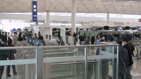 Flight-passengers-go-through-security-and-camera-survaillance-at-the-international-airport-departure-hall-in-Hong-Kong