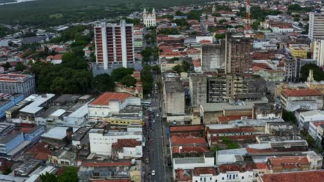 Tilt-up-aerial-shot-revealing-the-beautiful-historic-old-downtown-of-the-tropical-coastal-capital-city-of-Joao-Pessoa,-Paraiba,-Brazil-with-old-building-cityscape,-cathedrals,-and-large-river-behind