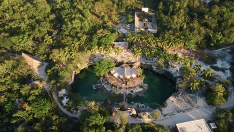 Cenote-of-water-surrounded-by-vegetation-at-Casa-Tortuga,-Tulum,-Mexico