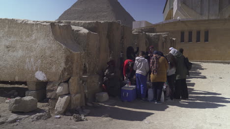A-family-visiting-the-pyramids-in-Egypt---a-long-shot