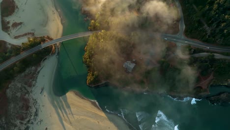 Drone-shot-of-California's-famous-Pacific-Coast-Highway-crossing-beaches-and-rivers-in-the-morning-glow
