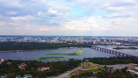 Wide-Dnipro-river-landscape,-Ukrainian-flag,-Kyiv,-Ukraine