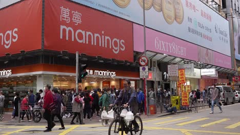 Establishing-shot-of-Mannings-store-and-street-in-Hong-Kong,-tilt-down
