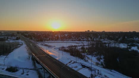 aerial-sunrise-over-a-highway-in-city