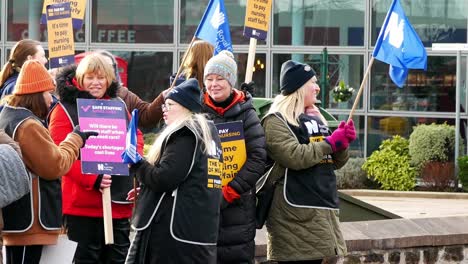 Overworked-NHS-staff-at-Whiston-hospital-in-Merseyside-dispute-on-the-picket-line-with-banners-and-flags-demanding-fair-pay-conditions