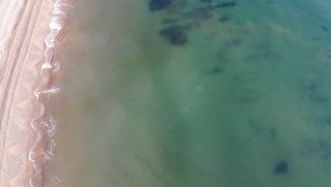 Aerial-Birds-Eye-View-Of-Sea-Waves-Breaking-On-Ladram-Bay-Beach