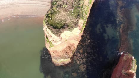Spectacular-drone-footage-showcases-the-stunning-seascape-of-Ladram-Bay,-with-beautiful-cliffs-and-clear-water-perfect-for-a-vacation