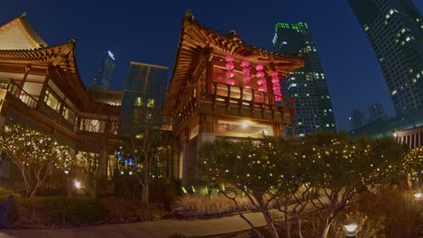 Korean-asian-traditional-national-park-architecture-buildings-in-the-evening-night-city-town-urban-style,-Incheon-Songdo,-Chinese,-Japanese,-oriental-skyscrapers-and-constructions-wide-angle-viewpoint