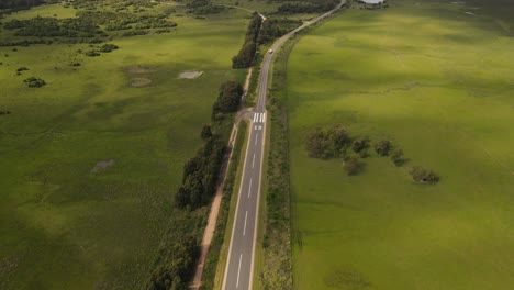 Isolated-truck-driving-along-emergency-airstrip-on-rural-road-in-Uruguayan-countryside