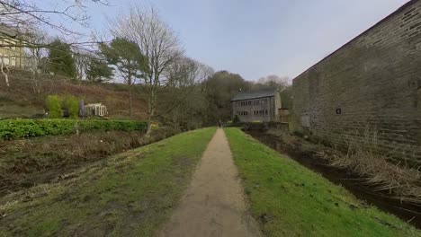 Video-footage-moving-down-a-riverside-country-pathway