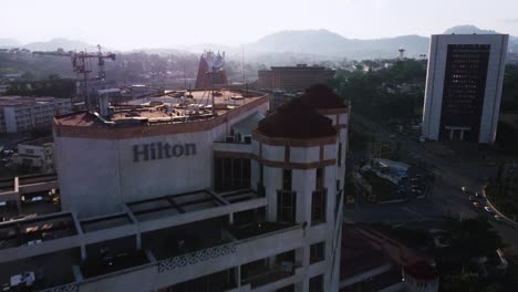 Aerial-view-over-the-Hilton-hotel,-revealing-the-the-Ministry-of-Posts-and-Telecommunications-and-the-Department-of-Basic-Education,-in-sunny-Yaounde,-Cameroon