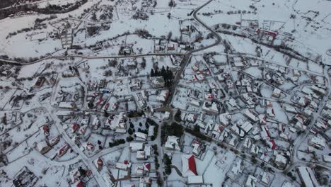 Village-of-Voskopoja-with-streets,-guesthouses-and-hotels-covered-in-snow,-mountain-tourism-in-Albania