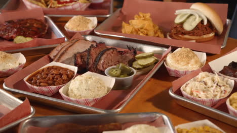 Trays-filled-with-many-Texas-Barbecue-options,-brisket-ribs-sausage,-slider-4K