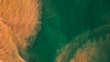 Muddy-floodwaters-spilling-into-the-ocean,-Drone-view