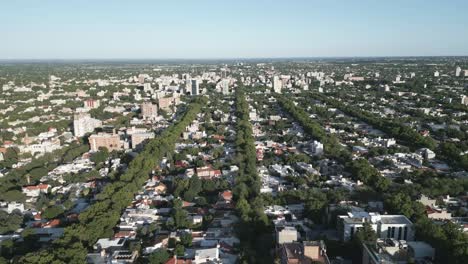 Aerial-City-View-of-Mendoza-Urban-Center,-Argentina-on-Clear-Daylight,-Buildings-Architecture-and-Green-Treetops-of-Famous-Vineyards-Travel-Destination