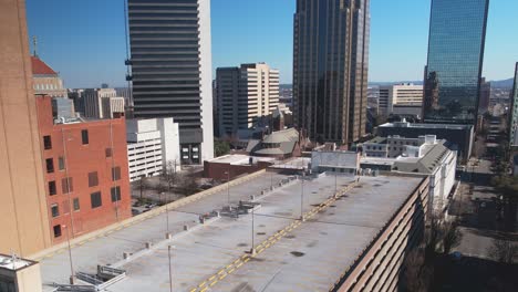 Beautiful-aerial-view-of-downtown-cityscape-of-Birmingham,-Alabama-revealing-skyscrapers-in-front-of-a-gorgeous-blue-skyline