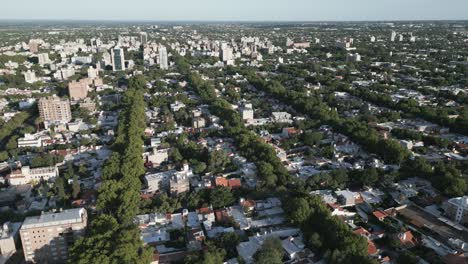 Establishing-Aerial-Drone-Shot-Above-Mendoza-City,-Argentina,-Cityscape-of-Urban-Metropolitan-Area,-Buildings,-Streets,-Treetops-during-Clear-Weather