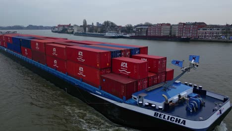 Aerial-Tracking-Shot-Off-Starboard-Side-Of-Belicha-Inland-Freighter-Transporting-Intermodal-Containers-Along-Oude-Maas