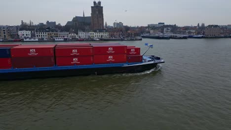 Drone-Parallax-Shot-Off-Starboard-Side-Of-Belicha-Inland-Freighter-Transporting-Intermodal-Containers-Along-Oude-Maas