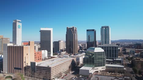 Beautiful-aerial-view-of-downtown-cityscape-of-Birmingham,-Alabama-with-wide-orbit-of-bustling-urban-landscape
