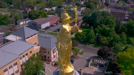 drone-revolves-around-the-gold-justice-statue-on-top-of-the-Beautiful-Courthouse-in-Canandaigua,-New-York-near-Canandaigua-Lake