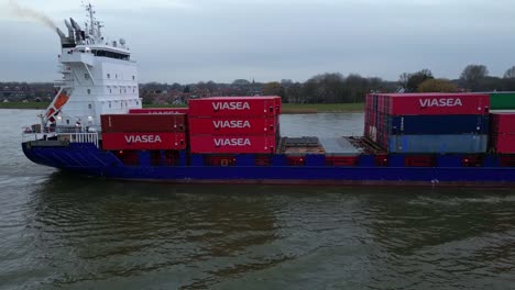 Aerial-View-Of-Starboard-Energy-Cargo-Ship-Carrying-Viasea-Intermodal-Containers-Passing-Along-Oude-Maas