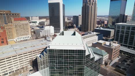 Beautiful-aerial-view-of-downtown-cityscape-of-Birmingham,-Alabama-pulling-away-from-courthouse-building-to-reveal-skyscrapers-in-background