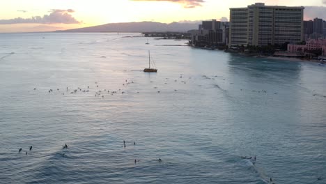 Hora-Azul-De-La-Playa-De-Waikiki-Surfistas-Al-Atardecer-Y-Navegación-En-Catamarán