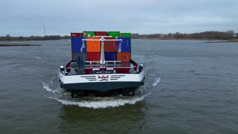 Aerial-Around-Forward-Bow-Of-Moonlight-Inland-Motor-Freighter-Sailing-Along-Beneden-Merwede-Carrying-Intermodal-Containers