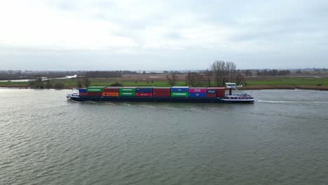 Aerial-View-Of-Port-Side-Of-Moonlight-Inland-Motor-Freighter-Sailing-Along-Beneden-Merwede-Carrying-Intermodal-Containers