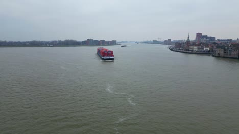 Aerial-View-Of-Belicha-Inland-Freighter-Transporting-Intermodal-Containers-Turning-Along-Oude-Maas