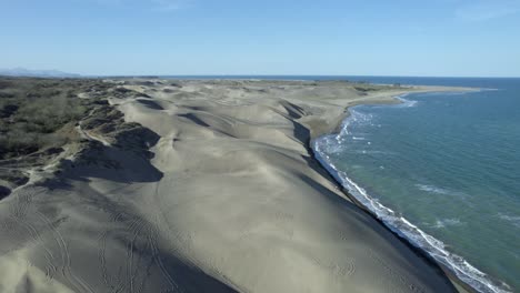 Drone-with-a-view-of-the-dunes-at-the-Beach-of-Chachalacas-in-Veracruz-and-following-a-four-wheeled-near-the-coast