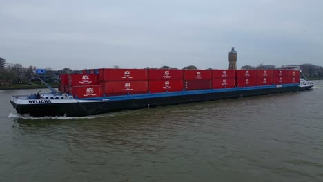 Intermodal-Containers-Loaded-In-Belicha-Vessel-Traveling-Near-Dordrecht,-South-Holland,-Netherlands