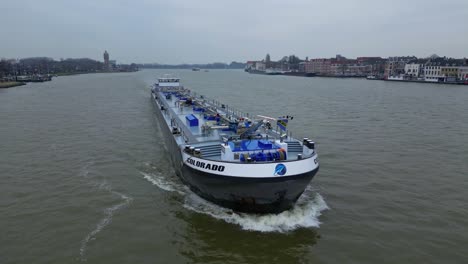 Aerial-Off-Forward-Bow-Of-Colorado-Inland-Liquid-Cargo-Ship-Sailing-Past-Along-Oude-Maas