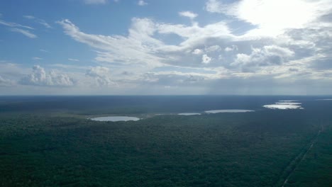 Aerial-panoramic-view-from-left-to-right,-over-deforestation-on-the-line-of-"Tren-Maya"-train-project,-Quintana-Roo,-Mexico,-at-ten-kilometres-of-"Felipe-Carrillo-Puerto