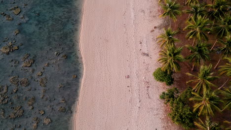 Sunset-golden-hour-on-beach-colourful-red-orange-sun-blue-sea-and-white-sand-in-asia-with-drone