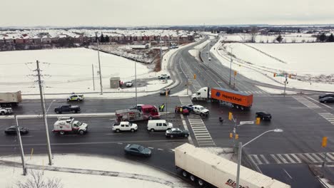 Aerial-forward-view-of-an-incident-roads-at-an-intersection-in-the-snow
