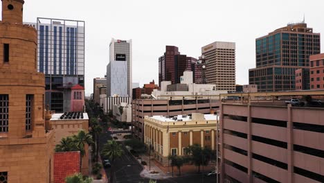 Aerial-view-passing-by-a-church-steeple-to-reveal-the-rest-of-downtown-Phoenix,-Arizona-after-a-storm