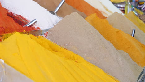 Close-up-of-the-typical-colorful-spice-mounds-arranged-in-a-street-stall-in-an-Arabian-city