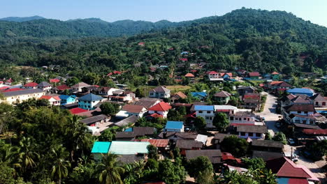 Small-town-with-any-colorful-houses-in-a-green-forrest-with-many-trees