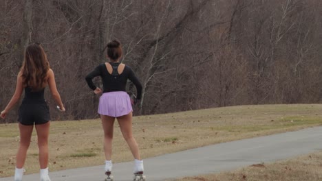 Young-women-rollerskating-in-the-park-during-winter