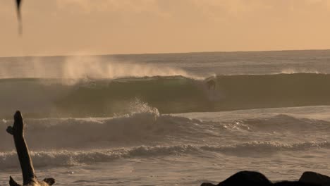 Slow-motion-surfers-at-Burleigh-Heads-at-sunrise-on-the-Gold-Coast,-Queensland,-Australia