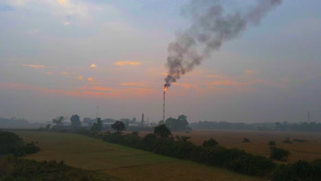 Beautiful-sunrise-ruined-by-the-black-smoke-being-released-from-factory-chimneys