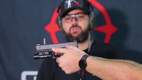 Balancing-a-bullet-on-a-semiautomatic-pistol-to-demonstrate-smooth-trigger-pull