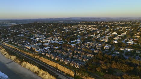 Aerial-view-of-oceanside-neighborhood-in-San-Diego,-sunset-in-CA,-USA---reverse,-drone-shot