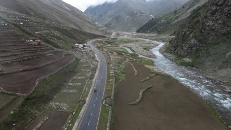 Highlands-of-Pakistan,-Babusar-Pass,-Kinar-River-and-Rickshaw-on-Karakoram-Highway,-Drone-Aerial-View