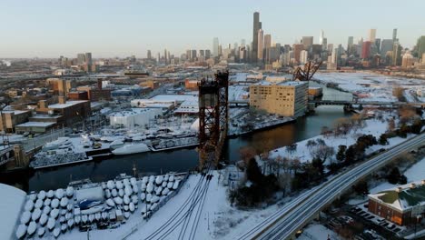 Aerial-view-circling-the-Canal-Street-railroad-bridge,-winter-morning-in-Chicago,-USA